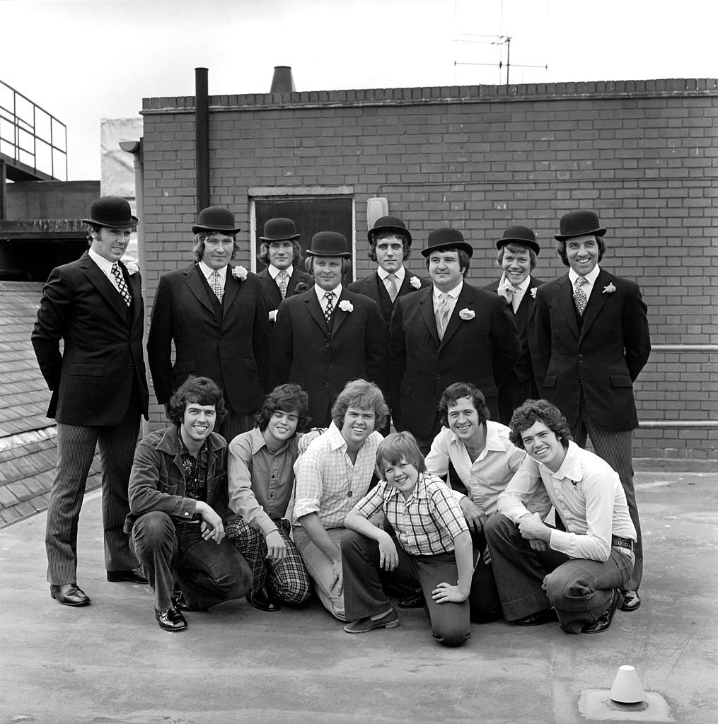 Image Source: Getty Images/Mirrorpix/The Osmond Brothers pop group pose with body guards dressed as city gents with bowler hats.