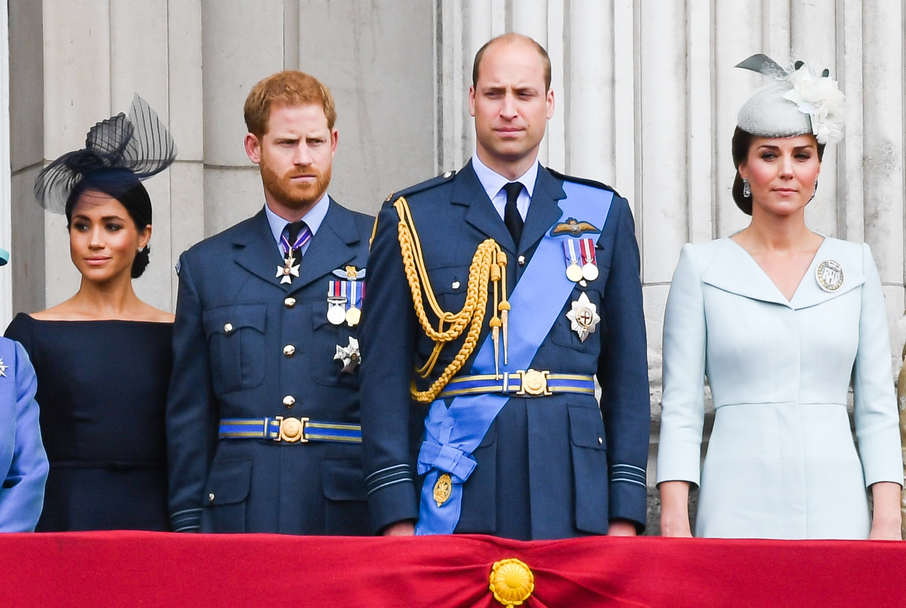 Image Credits: Getty Images / Anwar Hussein / WireImage | Meghan, Duchess of Sussex, Prince Harry, Duke of Sussex, Prince William, Duke of Cambridge and Catherine, Duchess of Cambridge stand on the balcony of Buckingham Palace to view a flypast to mark the centenary of the Royal Air Force (RAF) on July 10, 2018 in London, England.