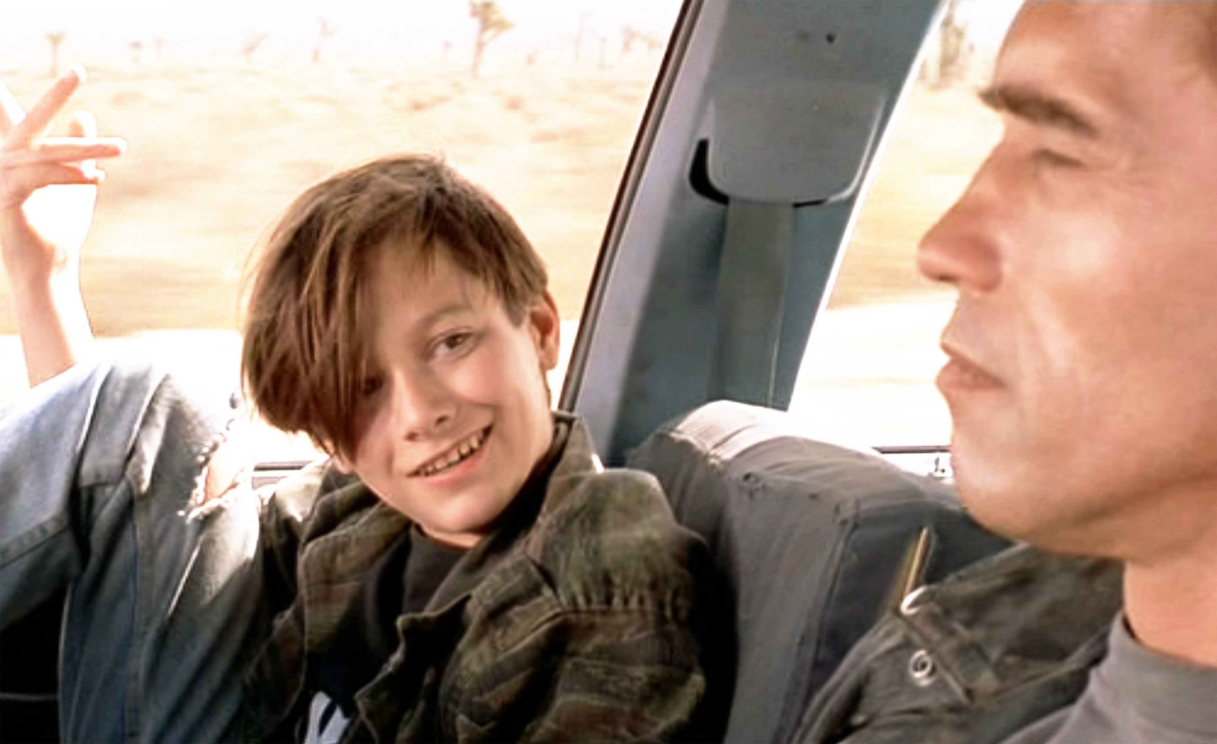 Image Credits: Getty Images / CBS / Paramount Pictures | The movie "Terminator 2: Judgment Day", (alt: T2) directed by James Cameron. Seen here from left, Edward Furlong (as John Connor) and Arnold Schwarzenegger (as the T-800 Terminator). John teaches the Terminator various ways to respond to situations. Example: You don't say affirmative () You say, No problemo. Theatrical wide release July 3, 1991.
