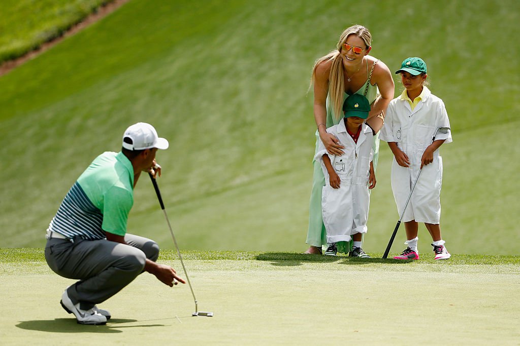 Image Credits: Getty Images / Ezra Shaw | Tiger Woods of the United States waits a green as his girlfriend Lindsey Vonn, son Charlie and daughter Sam look on during the Par 3 Contest prior to the start of the 2015 Masters Tournament at Augusta National Golf Club on April 8, 2015 in Augusta, Georgia. Image Credits: Getty Images / Ezra Shaw | Tiger Woods of the United States waits a green as his girlfriend Lindsey Vonn, son Charlie and daughter Sam look on during the Par 3 Contest prior to the start of the 2015 Masters Tournament at Augusta National Golf Club on April 8, 2015 in Augusta, Georgia.