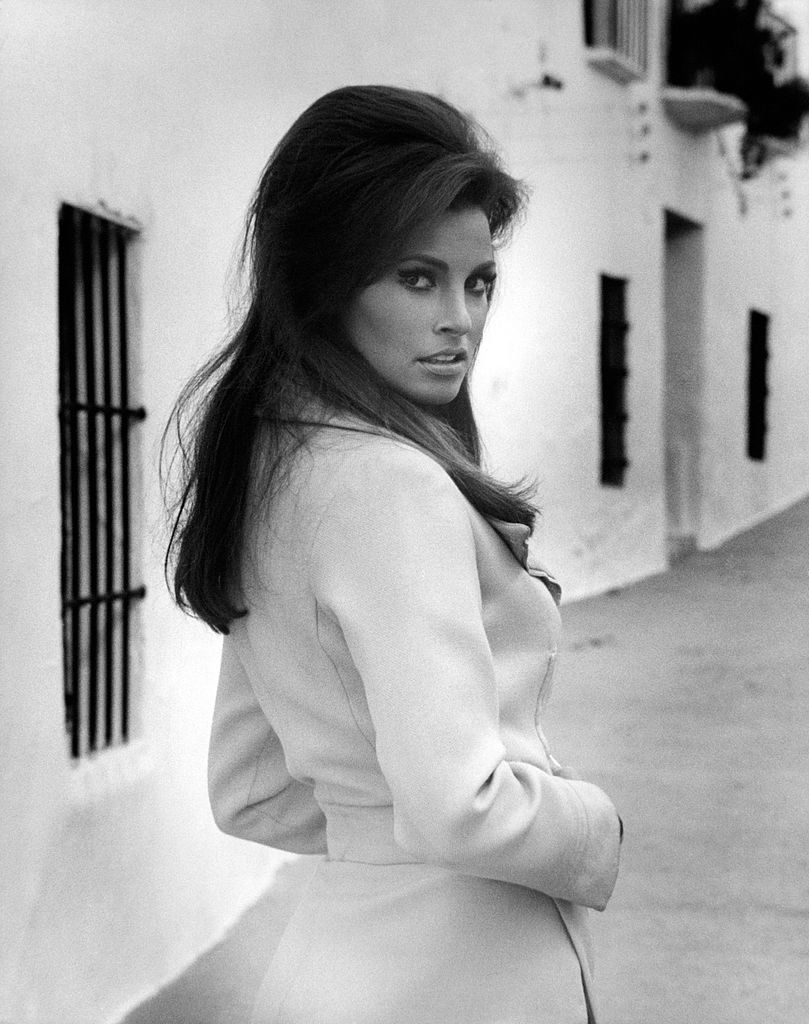Image Source: Getty Images| Raquel posing wearing a trench coat Image Source: Getty Images| Raquel posing wearing a trench coat