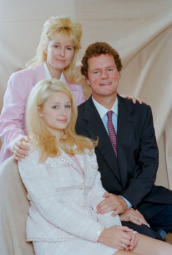 Image Credits: Getty Images / Colin Davey | American socialite and television personality Paris Hilton with her parents, Kathy and Richard Hilton, 5th July 1996.