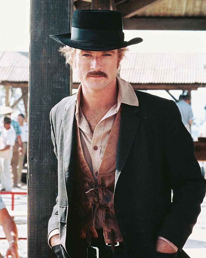 Image Credits: Getty Images / Silver Screen Collection | Robert Redford, US actor, in a Western costume, with a black cowboy hat and tan leather waistcoat, in a publicity portrait issued for the film, 'Butch Cassidy and the Sundance Kid', 1969. The Western, directed by George Roy Hill (1921-2002), starred Redford as 'The Sundance Kid'.