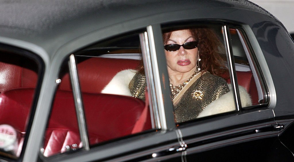 Image Credits: Getty Images / Gareth Cattermole | Celebrity Big Brother III housemate Jackie Stallone poses for photographs outside the Big Brother house, before her surprise entry to the house at Elstree Studios on January 10, 2004 in Hertfordshire, England.