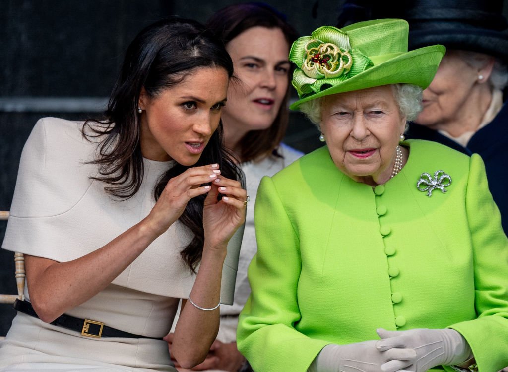 Image Credit: Getty Images / Queen Elizabeth II and Meghan, Duchess of Sussex during a visit to the Catalyst Museum by the Mersey Gateway Bridge on June 14, 2018 in Widnes, England.