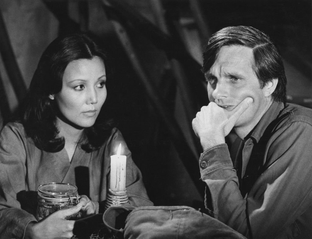Image Credits: Getty Images / CBS Photo Archive | Kieu Chinh and Alan Alda star in 'In Love and War', an episode of 'M*A*S*H',