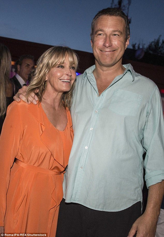 Image Credits: Shutterstock / / The model and Hollywood actor Bo Derek and John Corbett are photographed by the press.