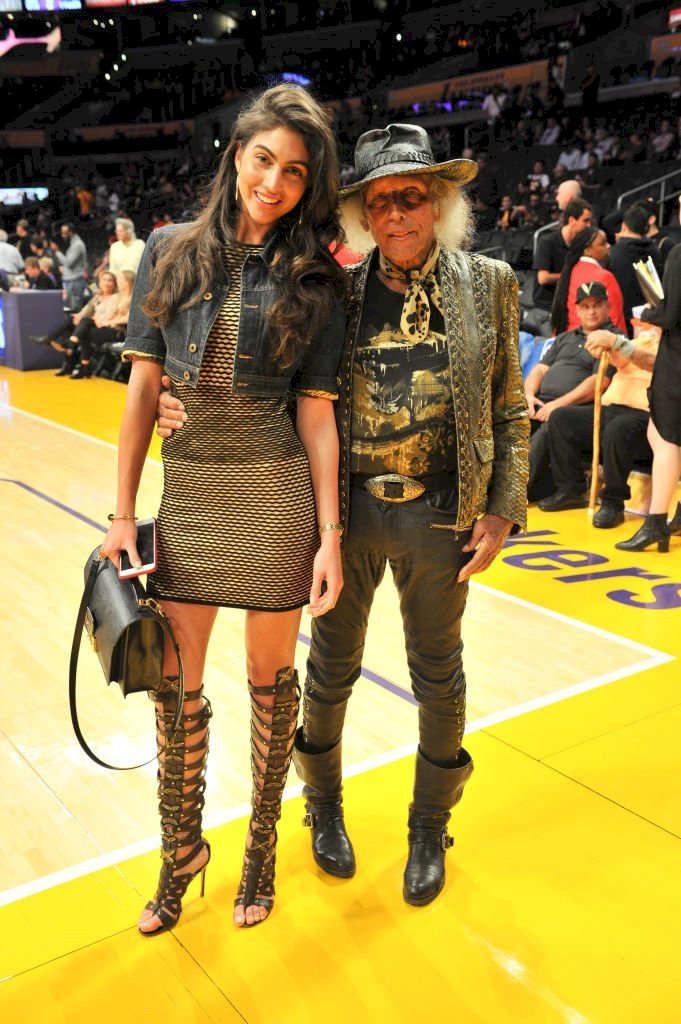 Image Credits: Getty Images / Allen Berezovsky | Jimmy Goldstein (R) and model Simone Aptekman attend a basketball game between the Los Angeles Lakers and the Philadelphia 76ers at Staples Center.