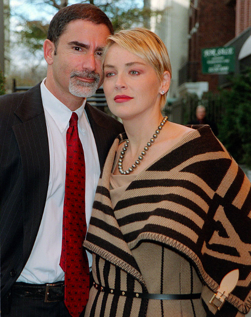 Image Credits: Getty Images / Sharon Stone and her husband Phil Bronstein stand outside their hotel