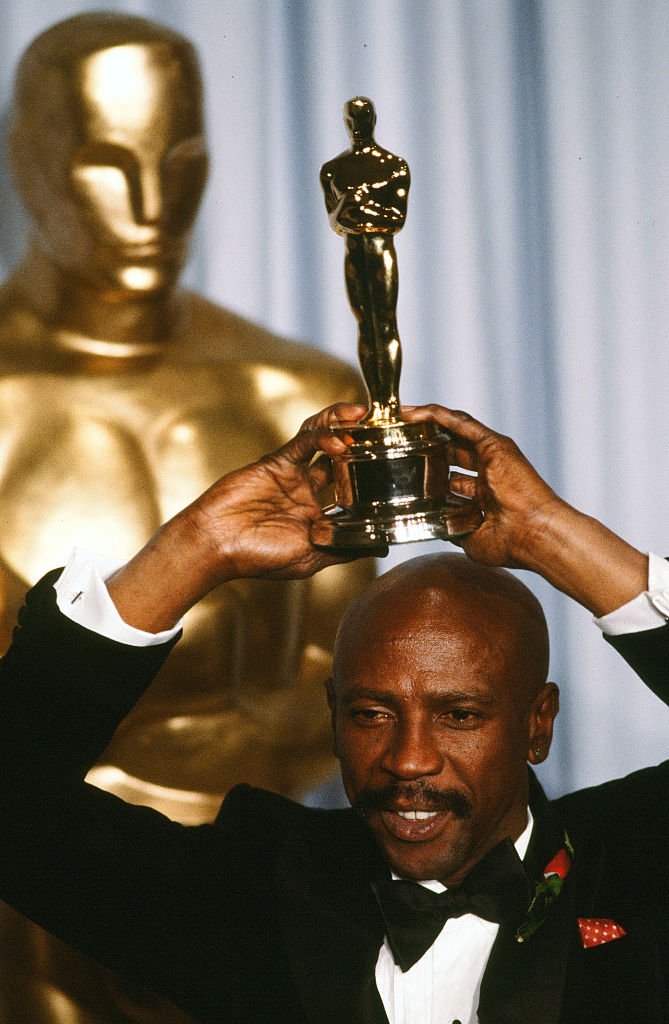 Image Credits: Getty Images / Michael Montfort/Michael Ochs Archives | Actor Louis Gossett, Jr. poses backstage after he wins "Best Supporting Actor" award