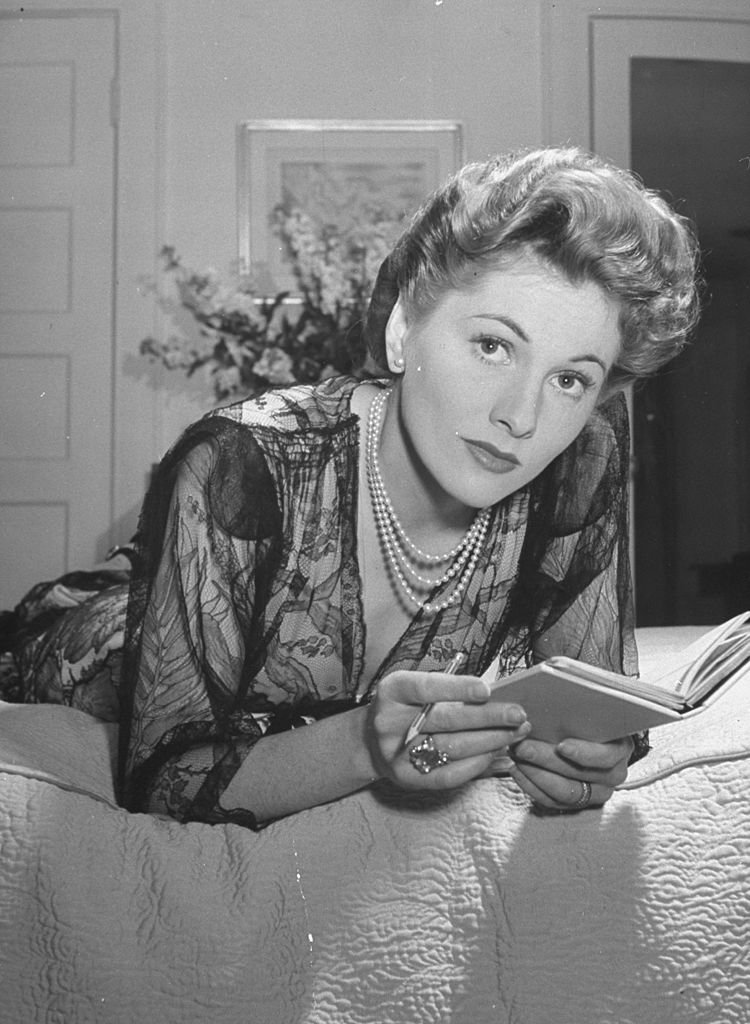Image Source: Getty Images/The LIFE Picture Collection//Bob Landry/Fontaine wearing sheer negligee while lounging on bed at home.
