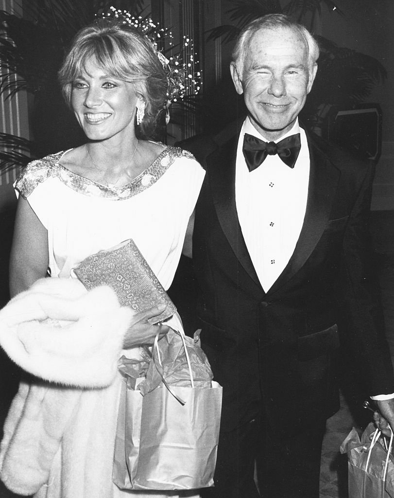 Image Credits: Getty Images / Kevin Winter | Television host Johnny Carson and his girlfriend Alex Maas attending the American Film Institute Awards at the Beverly Hilton Hotel, California, March 6th 1986.
