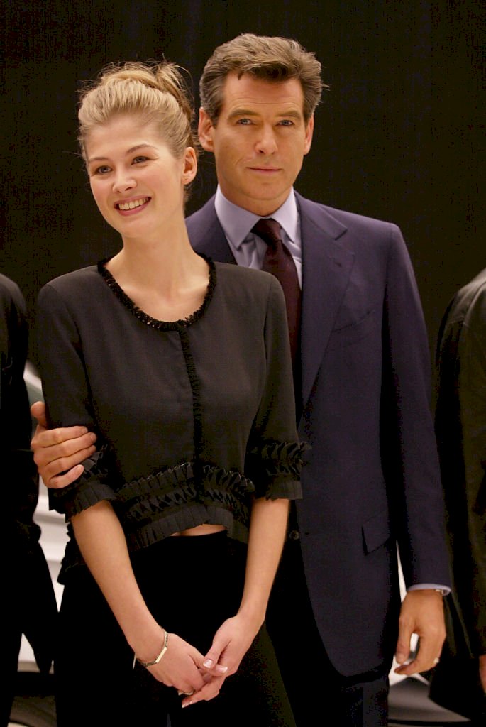 Image Credit: Getty Images / Rosamund Pike with her James Bond, Pierce Brosnan.