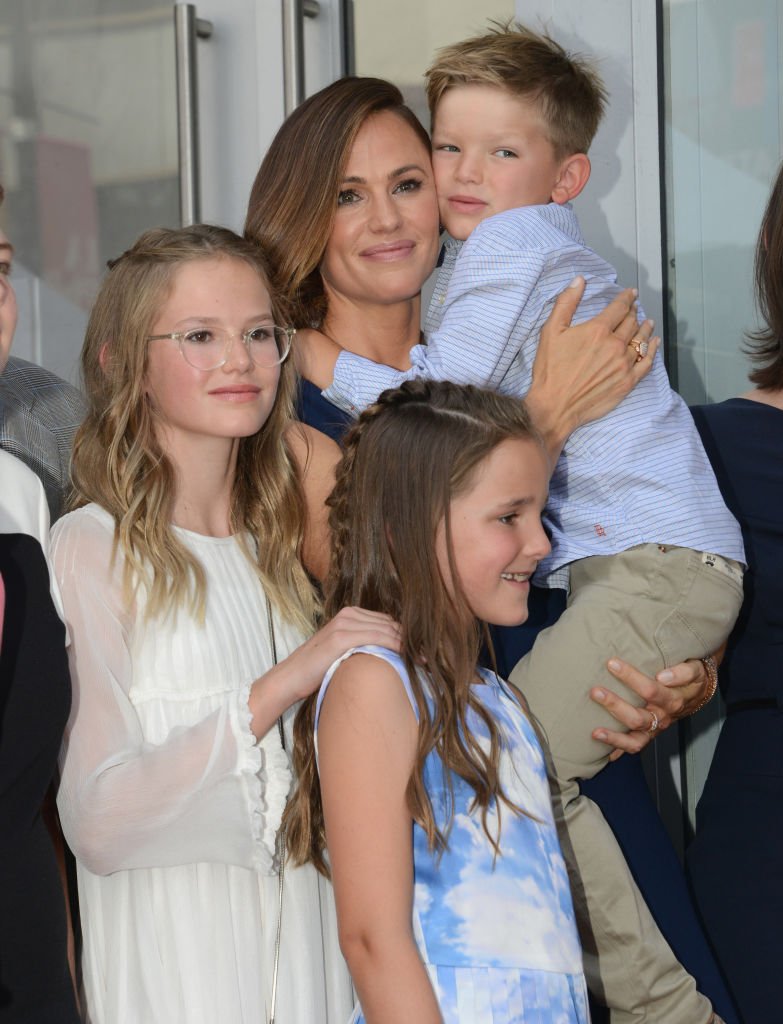 Image Credits: Getty Images / Albert L. Ortega | Actress Jennifer Garner pose with children Violet Affleck, Samuel GarnerAffleck and Seraphina Rose Elizabeth Affleck during the ceremony honoring Jennifer Garner with a star on the Hollywood Walk Of Fame on August 20, 2018 in Hollywood, California.