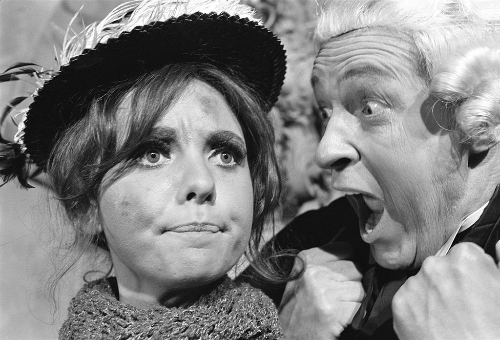 Image Credit: Getty Images / Gilligan's Island cast members, from left, Dawn Wells (as Mary Ann Summers, as flower seller) and Russell Johnson (as Professor Roy Hinkley, as prosecutor) in the episode: "And Then There Were None." Image dated October 19, 1966.