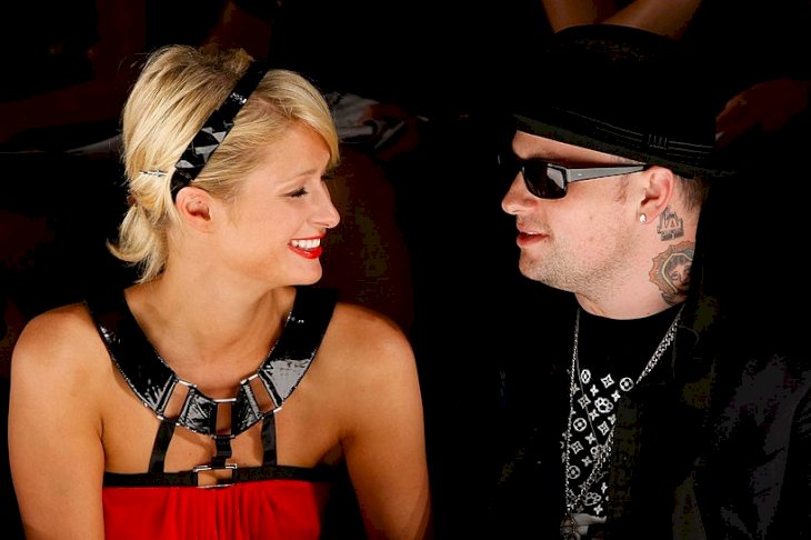 Image Credits: Getty Images / Michael Buckner | Socialite Paris Hilton and musician Benji Madden pose in the front row at the Nicholai By Nicky Hilton Fall 2008 fashion show during Mercedes-Benz Fashion Week held at Smashbox Studios on March 11, 2008 in Culver City, California.