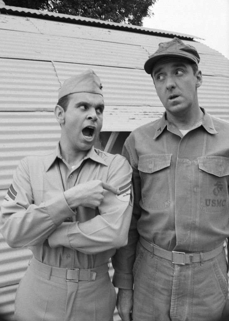 Image Source: Getty Images/CBS Photo Archive| American actors Ronnie Schell (left, as Pvt. Gilbert 'Duke' Slater) and Jim Nabors (as Pvt. Gomer Pyle) stand outside a Quonset hut during the filming of an episode of the television comedy series
