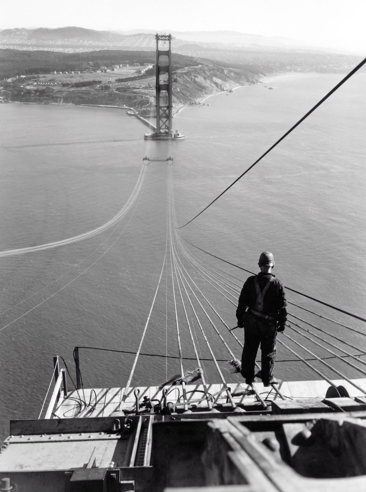 A man stands on the first cables of the Golden Gate Bridge during its construction,1935. Image Source: YouTube/Medium A man stands on the first cables of the Golden Gate Bridge during its construction,1935. Image Source: YouTube/Medium