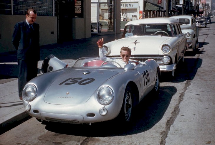 Image Credit: Getty Images / Actor James Dean gives a thumbs-up sign from his Porsche 550 Spyder.