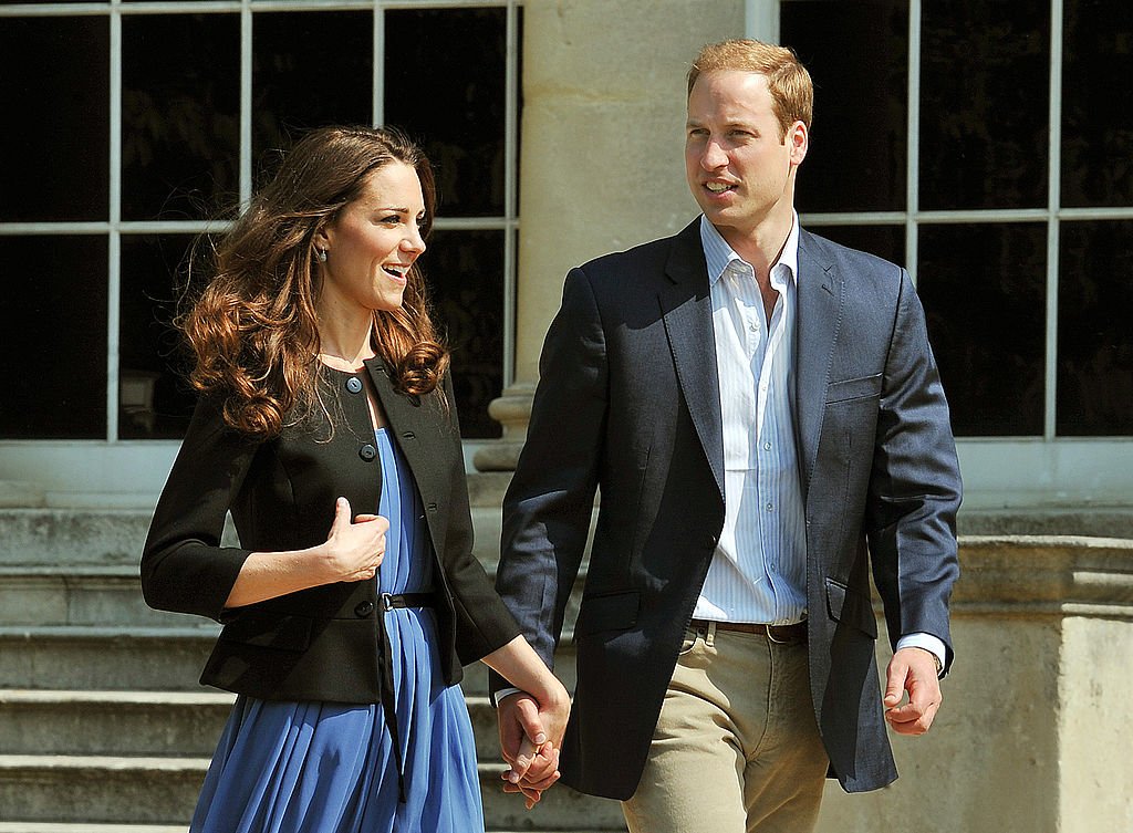 Image Credit: Getty Images / Prince William, Duke of Cambridge and Catherine, Duchess of Cambridge walk hand in hand from Buckingham Palace the day after their wedding to a waiting helicopter as they leave for a secret honeymoon location, on April 30, 2011 in London.