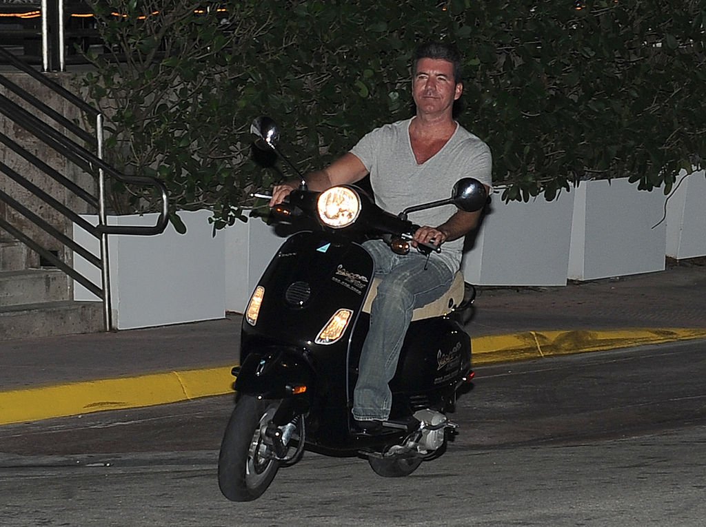 Image Credit: Getty Images / Simon Cowell is seen riding his scooter on March 04, 2014 in Miami, Florida.