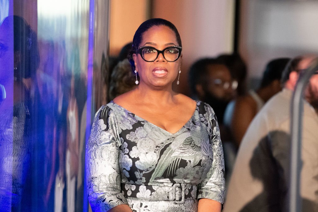 Image Credit: Getty Images / Oprah Winfrey stands off stage in anticipation of her honor at "Watching Oprah: The Oprah Winfrey Show And American Culture" Press Preview at National Museum Of African American History & Culture on June 7, 2018.