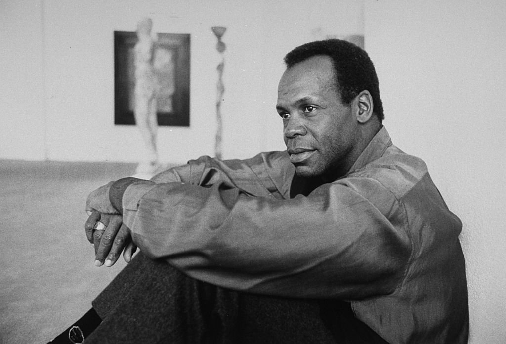 Image Source: Getty Images/Kim Komenich| Actor Danny Glover sitting on floor in art gallery Image Source: Getty Images/Kim Komenich| Actor Danny Glover sitting on floor in art gallery