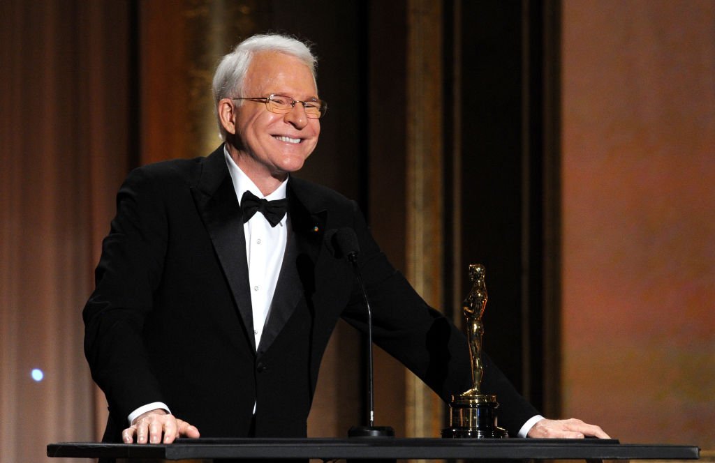 Image Credits: Getty Images / Kevin Winter | Honoree Steve Martin accepts honorary award onstage during the Academy of Motion Picture Arts and Sciences' Governors Awards at The Ray Dolby Ballroom at Hollywood & Highland Center on November 16, 2013 in Hollywood, California.