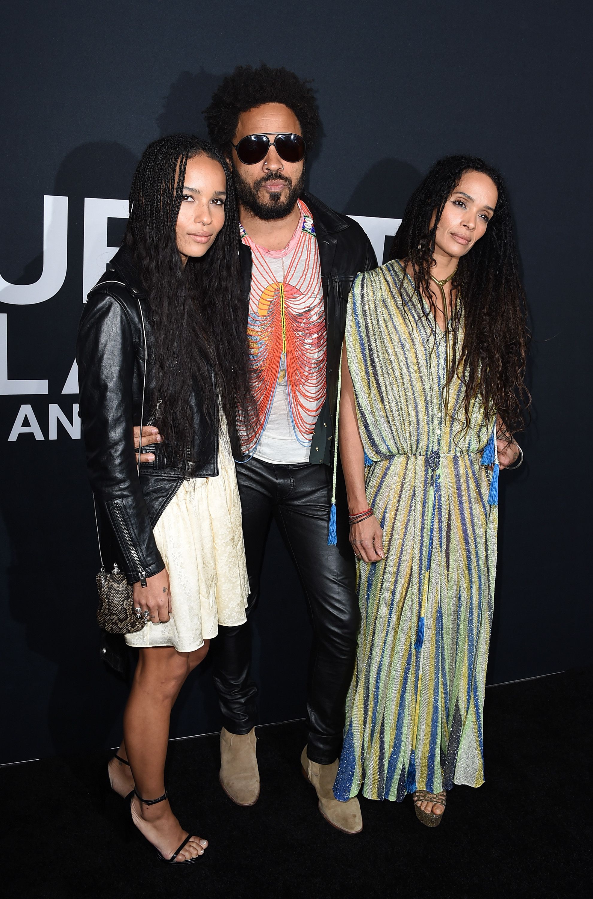 Musician Lenny Kravitz and actresses Zoe Kravitz and Lisa Bonet attend the Saint Laurent show / Getty Images
