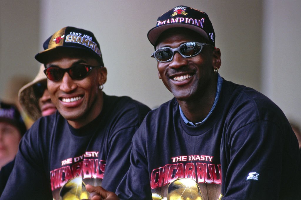 Image Credits: Getty Images / Steve Woltman / NBAE | Scottie Pippen #33, and Michael Jordan #23 of the Chicago Bulls are seen smiling at the Chicago Bulls Championship Parade and Rally on June 16, 1997 at Grant Park in Chicago, Illinois.