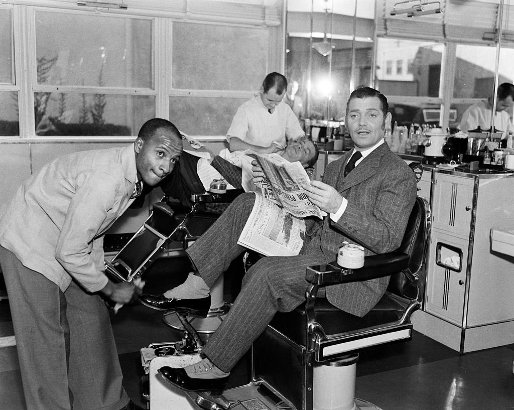 Image Credit: Getty Images / Actor Clark Gable poses in costume for the MGM film 'Parnell' as he gets his shoes shined in Los Angeles, California. Image Credit: Getty Images / Actor Clark Gable poses in costume for the MGM film 'Parnell' as he gets his shoes shined in Los Angeles, California.