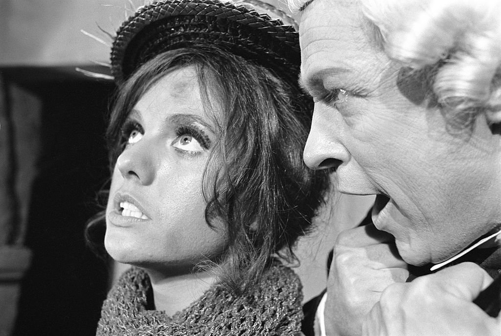 Image Credit: Getty Images / Gilligan's Island cast members, from left, Dawn Wells (as Mary Ann Summers, as flower seller) and Russell Johnson (as Professor Roy Hinkley, as prosecutor) in the episode: "And Then There Were None." Image dated October 19, 1966.