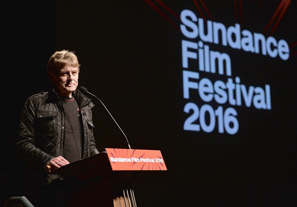 Image Credits: Getty Images / George Pimentel | Sundance Institute President and Founder Robert Redford speaks at the "Norman Lear: Just Another Version Of You" Premiere during the 2016 Sundance Film Festival at Eccles Center Theatre on January 21, 2016 in Park City, Utah.