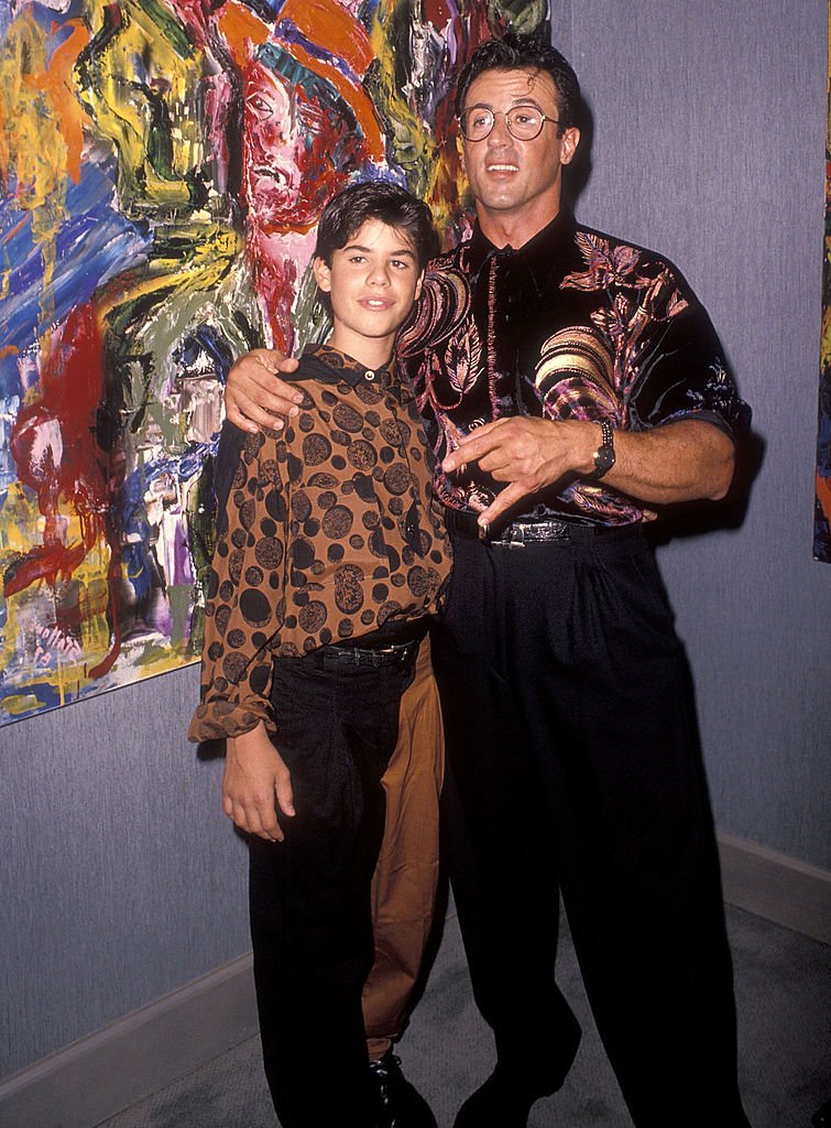 Image Credits: Getty Images / Ron Galella, Ltd. / Ron Galella Collection | Actor Sylvester Stallone and son Sage attend Sylvester Stallone's Paintings Opening Night Exhibition and Cocktail Reception to Benefit Yes on Proposition 128 "Big Green" on September 10, 1990 at Hanson Galleries in Beverly Hills, California.