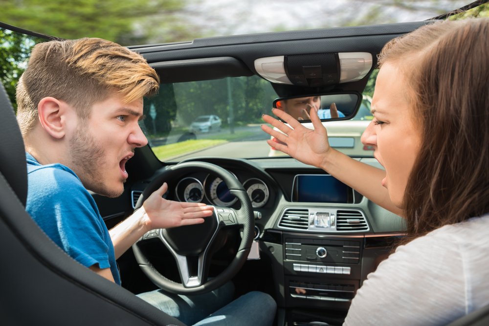 Couple fighting in car | Shutterstock Couple fighting in car | Shutterstock