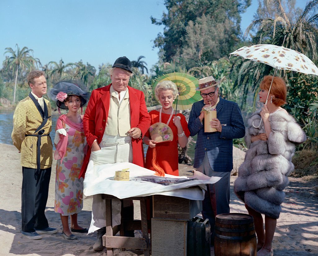 Image Credit: Getty Images / Filmed at the lagoon, CBS Studio Center, Studio City, CA. Image date, March 3, 1964. Original broadcast date October 3, 1964. Pictured from left is Russell Johnson (as Professor Roy Hinkley), Dawn Wells (as Mary Ann Summers), Alan Hale Jr. (as Jonas 'The Skipper' Grumby), Natalie Schafer (as Mrs. Lovey Howell), Jim Backus (as Thurston Howell III), Tina Louise (as Ginger).