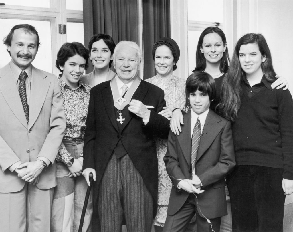 Image Source: Getty Images/Aubrey Hart/Comic actor Charlie Chaplin (1889 - 1977) with his wife Oona O'Neill (1925 - 1991) and family at the Savoy Hotel, London after Chaplin received his knighthood at Buckingham Palace, 4th March 1975