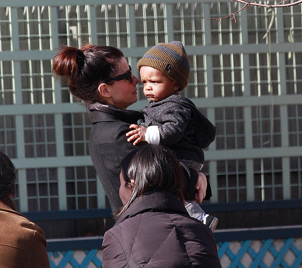 Image Credits: Getty Images / Marcel Thomas / FilmMagic | Actress Sandra Bullock and son Louis Bullock are seen on the streets of Manhattan on March 20, 2011 in New York City.