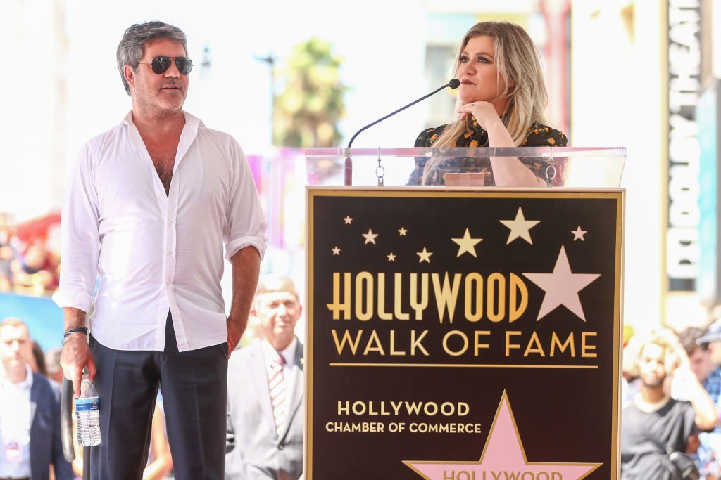 Image Credit: Getty Images / Simon Cowell (L) and Kelly Clarkson attend a ceremony honoring Cowell with a star on the Hollywood Walk of Fame on August 22, 2018.