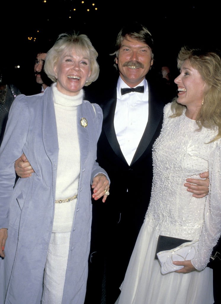 Image Credits: Getty Images / Jim Smeal / Ron Galella Collection | Doris Day (1922 - 2019), Terry Melcher and wife during First Annual Golden Cypress Awards at Hyatt Regency Hotel in Monterey, California, United States.