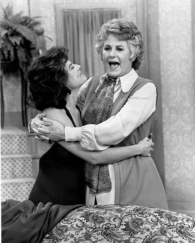 Image Credits: Getty Images / CBS Photo Archive | American actresses Adrienne Barbeau and Bea Arthur hug each other in a scene from the tv sitcom 'Maude,' 1972. Barbeau played Carol, the daughter of the title character portrayed by Arthur. Image Credits: Getty Images / CBS Photo Archive | American actresses Adrienne Barbeau and Bea Arthur hug each other in a scene from the tv sitcom 'Maude,' 1972. Barbeau played Carol, the daughter of the title character portrayed by Arthur.