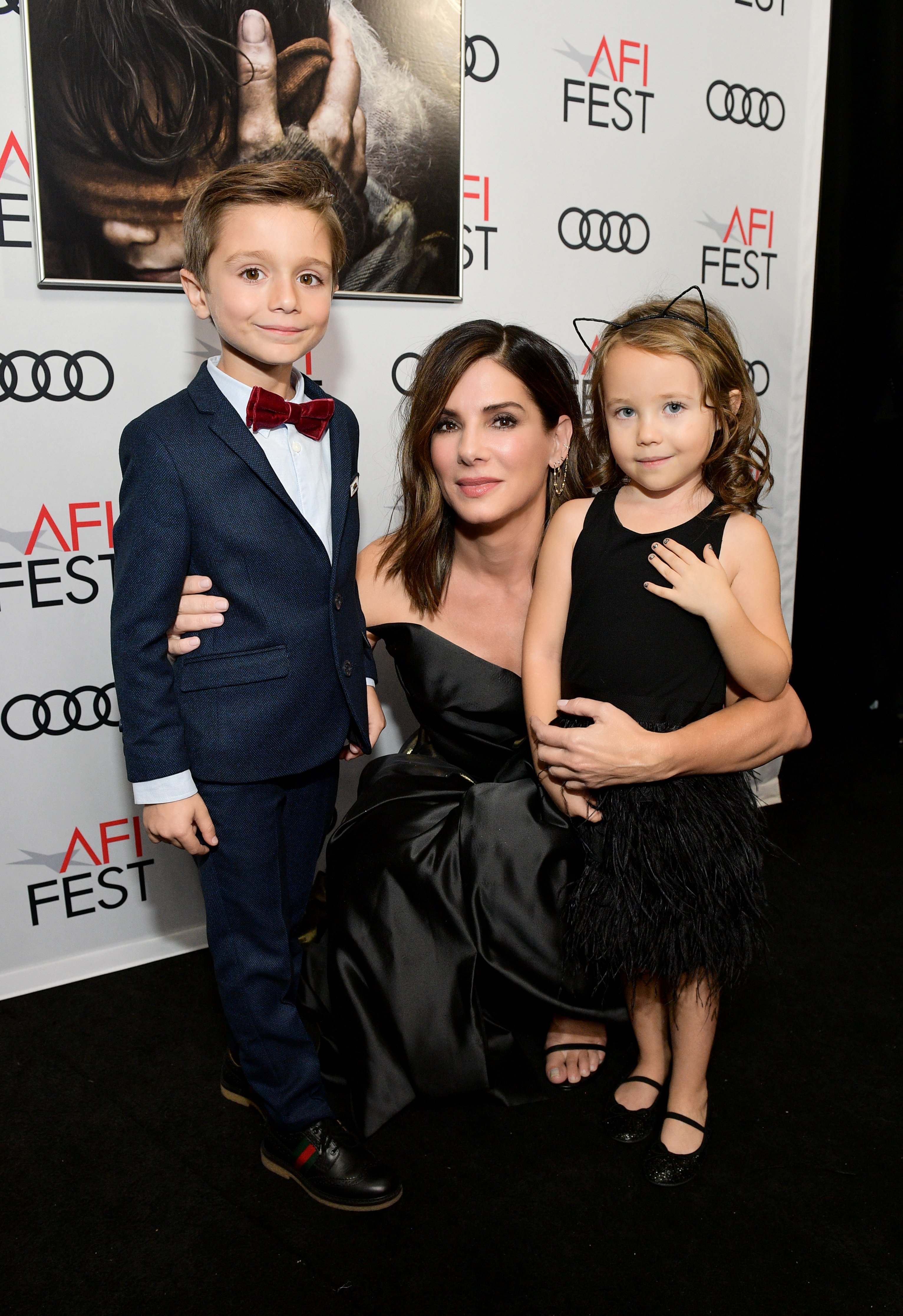 Image Credits: Getty Images / Matt Winkelmeyer | (L-R) Julien Edwards, Sandra Bullock, and Vivien Lyra Blair attend a screening of Netflix's 'Bird Box' at TCL Chinese Theatre on November 12, 2018 in Los Angeles, California.