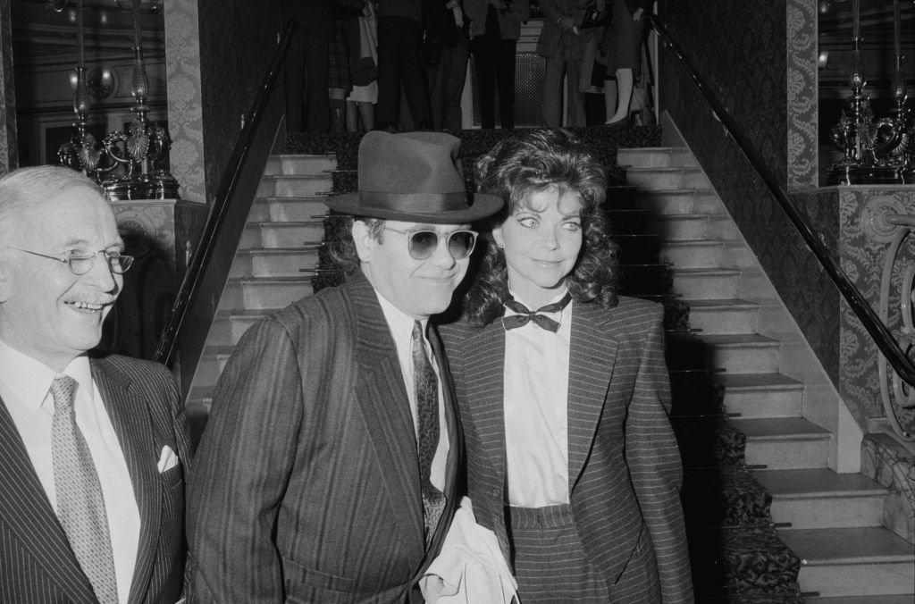 Image Credit: Getty Images / English singer and pianist Elton John with his wife Renate Blauel at the theatre, London, UK, 17th February 1985.