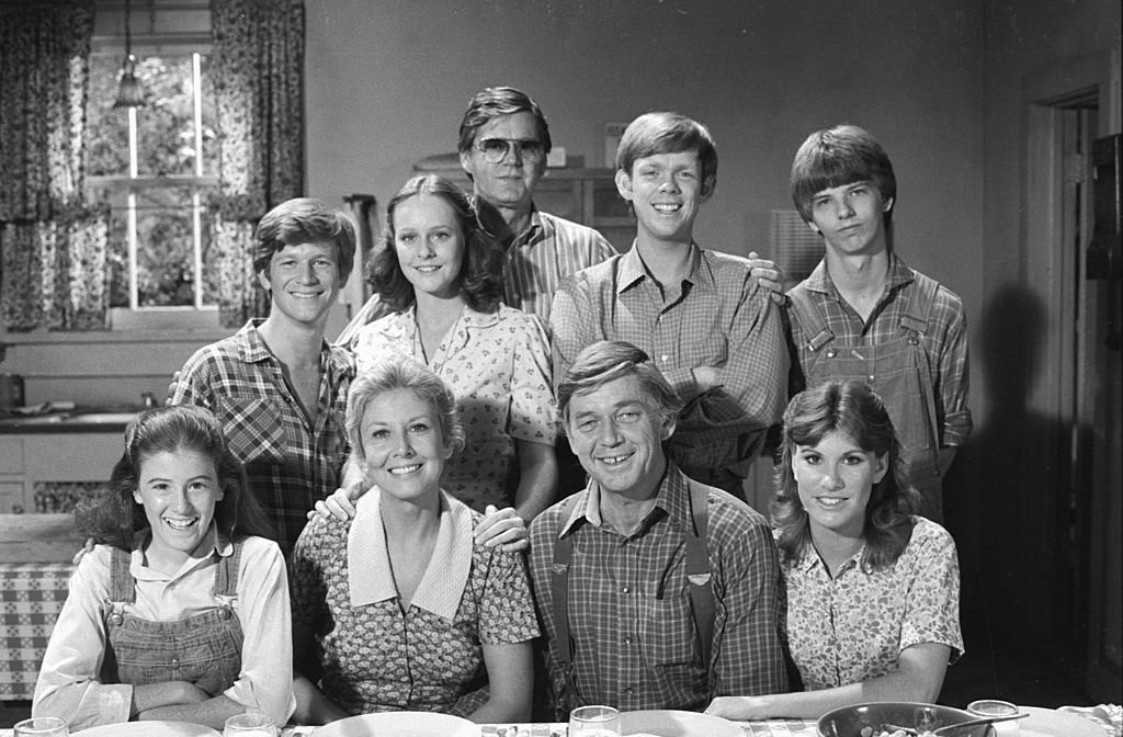Image Credits: Getty Images / CBS | THE WALTONS top row from left: Eric Scott as Ben Walton, Mary McDonough as Erin Walton, executive producer Earl Hamner, Jon Walmsley as Jason Walton, David Harper as Jim-Bob Walton. Bottom line from left: Kami Cotler as Elizabeth Walton, Michael Learned as Olivia Walton, Ralph Waite as John Walton, Judy Norton as Mary Ellen Walton. episode: "The Yearning". Image dated October 25, 1978.