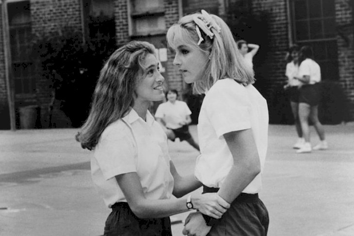 Image Credits: Getty Images / New World Pictures | Sarah Jessica Parker and Helen Hunt on the playground of their all girls Catholic school in a scene from the film 'Girls Just Want To Have Fun', 1985. Image Credits: Getty Images / New World Pictures | Sarah Jessica Parker and Helen Hunt on the playground of their all girls Catholic school in a scene from the film 'Girls Just Want To Have Fun', 1985.
