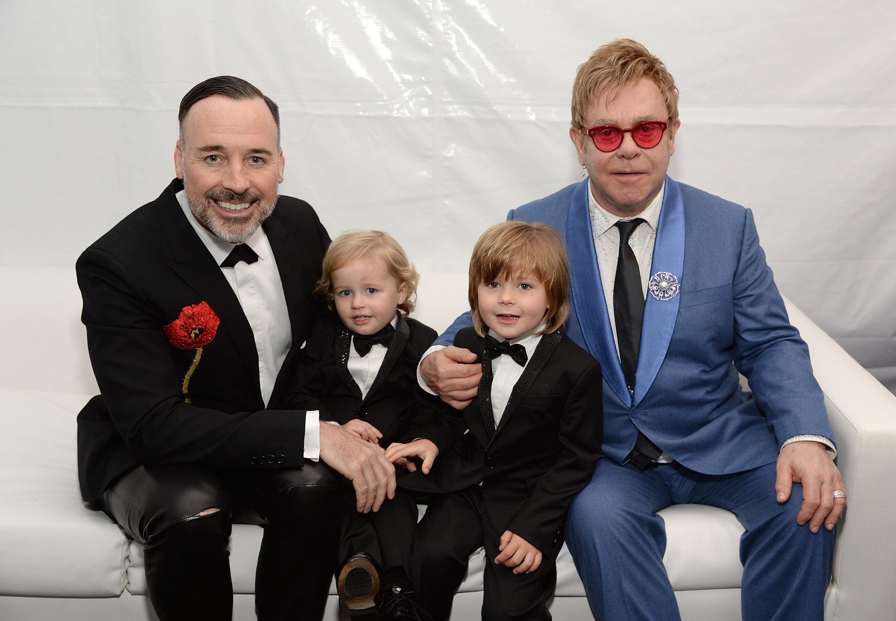 Image Credits: Getty Images / Elton John and David Furnish pose along with their children.