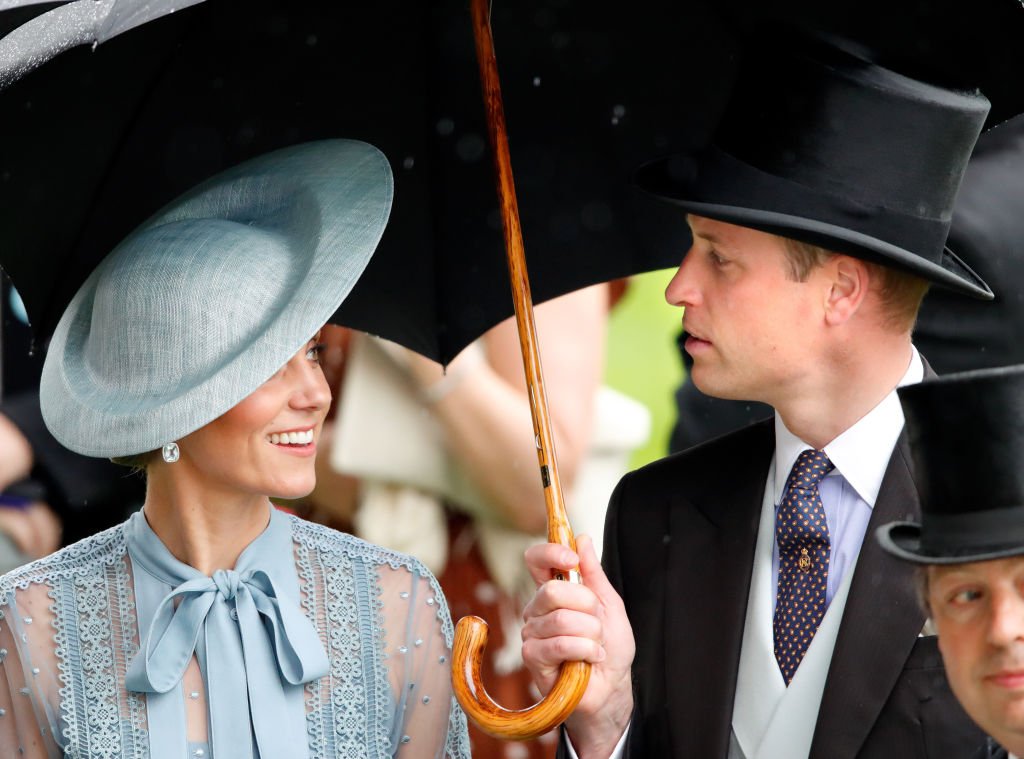 Image Credit: Getty Images / Catherine, Duchess of Cambridge and Prince William, Duke of Cambridge shelter under an umbrella as they attend day one of Royal Ascot at Ascot Racecourse on June 18, 2019 in Ascot, England.