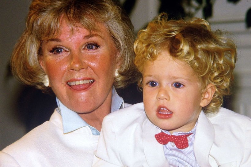 Image Credits: Getty Images / Paul Harris | Doris Day with her grandson Ryan Melcher 4, the son of her only child Terry Melcher at a press conference at the hotel she owns in Carmel, California July 16, 1985.