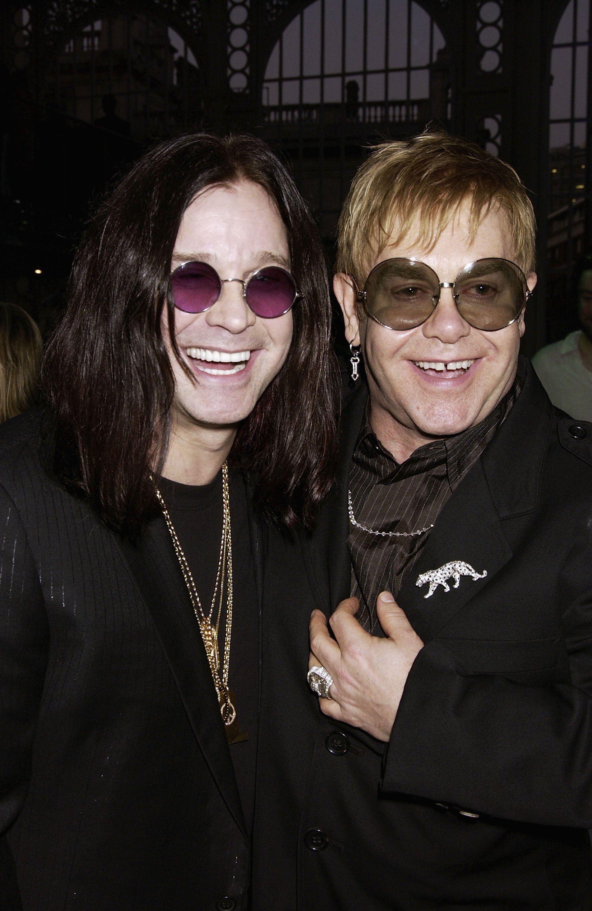 Image Credits: Getty Images / Elton John and Ozzy Osbourne smile for a photograph together.