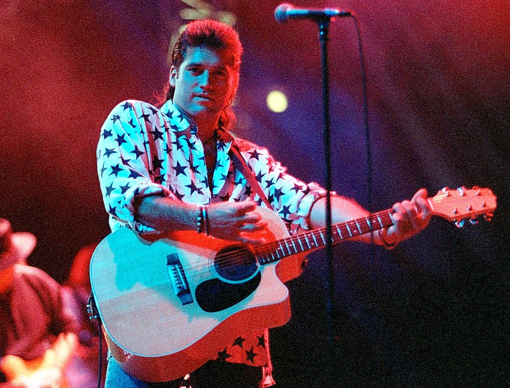 Image Credits: Getty Images / Rick Diamond | Billy Ray Cyrus performs at The Omni in Atlanta Georgia October 07, 1993